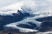 Tongue of the Vatnajokull Glacier creeping down the mountains behinf Fjallsarlon lagoon, South Iceland, Polar Regions