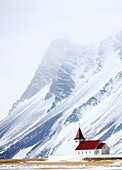 Church against snow covered mountains, winter afternoon, Snaefellsnes Peninsula, Iceland, Polar Regions