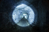 Photograph of tunnel in cave illuminated by flashlight, Inspiration Point, Yosemite National Park, California, USA