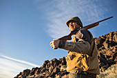 Man walks through the Nevada backcountry hunting Chukar.