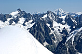 Climbers make their way along a ridge near the Aiguille du Midi on Mont Blanc in the French Alps of Chamonix, France