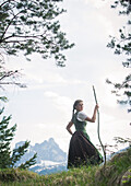 Young woman in traditional costume hiking on the Falkenstein in the Allgaeu, Pfronten, Bavaria, Germany