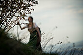 Young woman in traditional costume hiking on the Falkenstein in the Allgaeu, Pfronten, Bavaria, Germany