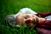 Caucasian woman laying in grass