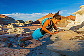 Native American woman doing push-up on rock in desert