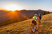 Caucasian couple mountain biking on trail