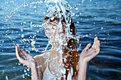 Caucasian woman splashing in ocean