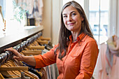 Caucasian woman shopping at clothing store