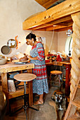 Mixed race woman shaping clay in art studio