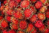 Pile of red spiny fruit