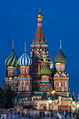 People in Red Square and illuminated St. Basil's Cathedral at dusk, Moscow, Russia