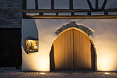 Elegant wine display case on half-timbered building with gate, Iphofen, Franconia, Bavaria, Germany
