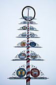 Maibaum may pole with traditional craftmaker emblems in Altstadt old town, Bayreuth, Franconia, Bavaria, Germany