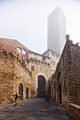 Via San Giovanni, alley, tower, fog, San Gimignano, hilltown, UNESCO World Heritage Site, province of Siena, Tuscany, Italy, Europe