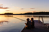 Children fishing on a boat dock, Sweden