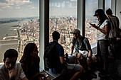 tourists contemplating manhattan from the top of the observatory at one world trade center, one world observatory,financial district, downtown, manhattan, new york city, state of new york, united states, usa