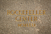 plaque engraved in the marble marking the entrance to rockefeller center, midtown, manhattan, new york city, state of new york, united states, usa