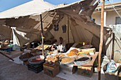 the berber market of ida oudgourd, ecotourism and hiking, in the market a vendor displays his fruits beneath a tent, a solely men's market, essaouira, mogador, atlantic ocean, morocco, africa