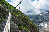 Hiker on a suspension bridge, Chamonix, Rhone Alpes, Haute Savoie, France, Europe