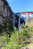 Bernina Express train on Landwasser Viadukt, UNESCO World Heritage Site, Filisur, Albula Region, Canton of Graubunden, Switzerland, Europe