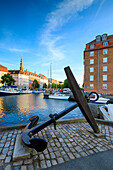 Sculpture of an anchor on the banks of Christianshavn Canal with Church of Our Saviour in the background, Copenhagen, Denmark, Europe