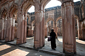 Muslim woman entering the semi-derelict 18th century Imambara and Mosque, Lucknow Residency, Uttar Pradesh, India, Asia