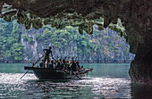 Vietnam, Ha Long Bay, the Tunnel Cave, tourists small boat (UNESCO World Heritage)