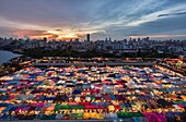 The colorful Ratchada Rot Fai Train Market at sunset, Bangkok, Thailand