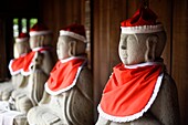 Statuettes wearing red woolen hats outside a Buddhist temple in Takayama, Japan, Asia