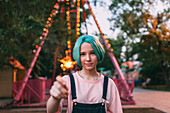 Portrait of smiling teenage girl holding illuminated sparkler