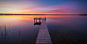 jetty at lake Ammersee at sunset, Bavaria, Germany