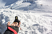 Germany, Bavaria, Alps, Oberallgaeu, Oberstdorf, Nebelhorn, Winter landscape, Winter holidays, Winter sports, Feeding a jackdaw, Alpine chough on the summit