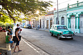 Oldtimer on an empty street, colonial town, family travel to Cuba, parental leave, holiday, time-out, adventure, Cienfuegos, Cuba, Caribbean island