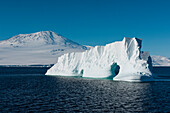 The 3794 meter volcano Mt. Erebus towers above an iceberg, Mt. Erebus, Antarctica