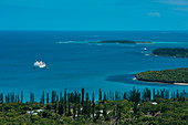 Expedition cruise ship MS Bremen (Hapag-Lloyd Cruises) lies at anchor surrounded by deep-blue waters, Ile des Pins, New Caledonia, South Pacific