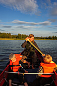 Family is on the canoe on Vaenersee Torsoe Island near Mariestad, Vänernsee, Sweden