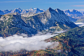 View towards Karwendel range and Guffert, fog in the valley, from Hinteres Sonnwendjoch, Bavarian Alps, Tyrol, Austria