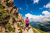 Hiker after climbing the Rosszahnscharte with a view of the Alpe di Siusi and the area around Mount Plattkofel, Siusi, South Tyrol, Alto Adige, Italy