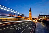 Doubledeckerbus runs towards Big Ben also called Elizabeth Tower, located north end of the Palace of Westminster in London United Kingdom Europe.