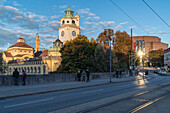 View from Ludwigsbruecke bridge to Muellersche Volksbad and Gasteig in autumnal evening light, Munich, Upper Bavaria, Germany