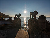 Sun over lake Starnberg in late autumn at the bathing area of Schloss Seeburg, Muensing, Upper Bavaria, Germany