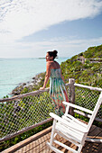 EXUMA, Bahamas. Nicole on a balcony of one of the villas at the Fowl Cay Resort.