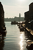 ITALY, Venice. A view of a canal, homes and stores on the Island of Murano.