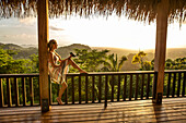 BELIZE, Punta Gorda, Toledo, Belcampo Belize Lodge and Jungle Farm, a guest enjoying all the amenities of the Ridge Suite, which offers stunning views, a private screened porch, outdoor soaking tubs and access to a salt water infinity pool