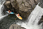 USA, Hawaii, The Big Island, Hilo, paddle boarding on the Wailuku River near the Singing Bridge