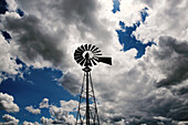 USA, Oregon, Grass Valley, a windmill stands beneath a dramatic cloudy sky