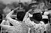 Young Women At A Religious Ceremony Carrying A Smoking Offering On Her Head; Bali, Indonesia