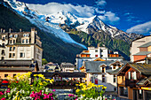 Mont Blanc over Chamonix town and L'Arve River with flowers; Chamonix-Mont-Blanc, Haute-Savoie, France