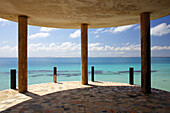 Terrace columns of abandoned coastal hotel against Indian Ocean, Mozambique