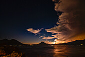 Thunderstorm clouds over volcano at sunset, Santa Catarina Palop, Solol, Guatemala